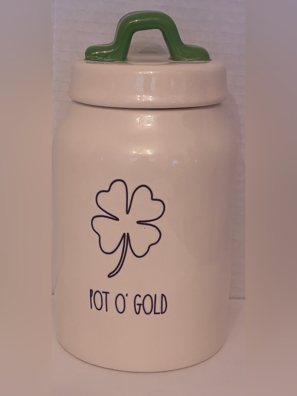 Rae Dunn off White Ceramic 'POT O’GOLD’ Canister with Green Handle
covered lid.
